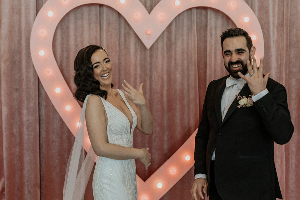 couple celebrating flash their wedding rings just married at Sure thing NYC wedding chapel new york wedding and elopement venue