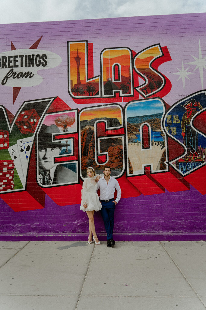 Couple Who Just Eloped in front of the Greeting From Las Vegas Mural captured by The Combs Creative 