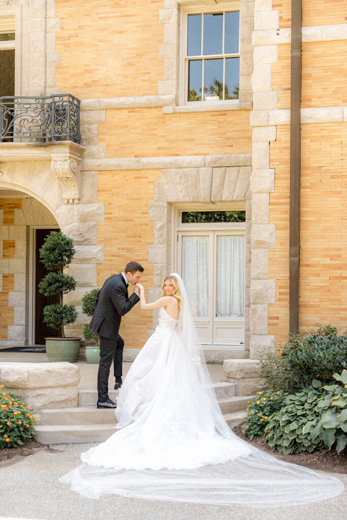 groom kissing the brides hand