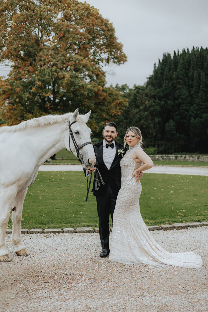 cute picture of the bride and groom with a horse