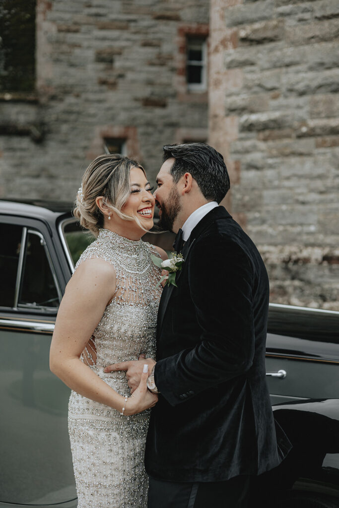 groom kissing the bride on the cheek