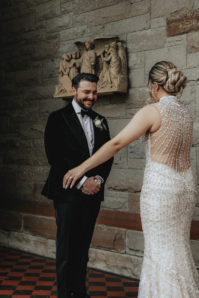 groom emotional seeing the bride in her wedding dress