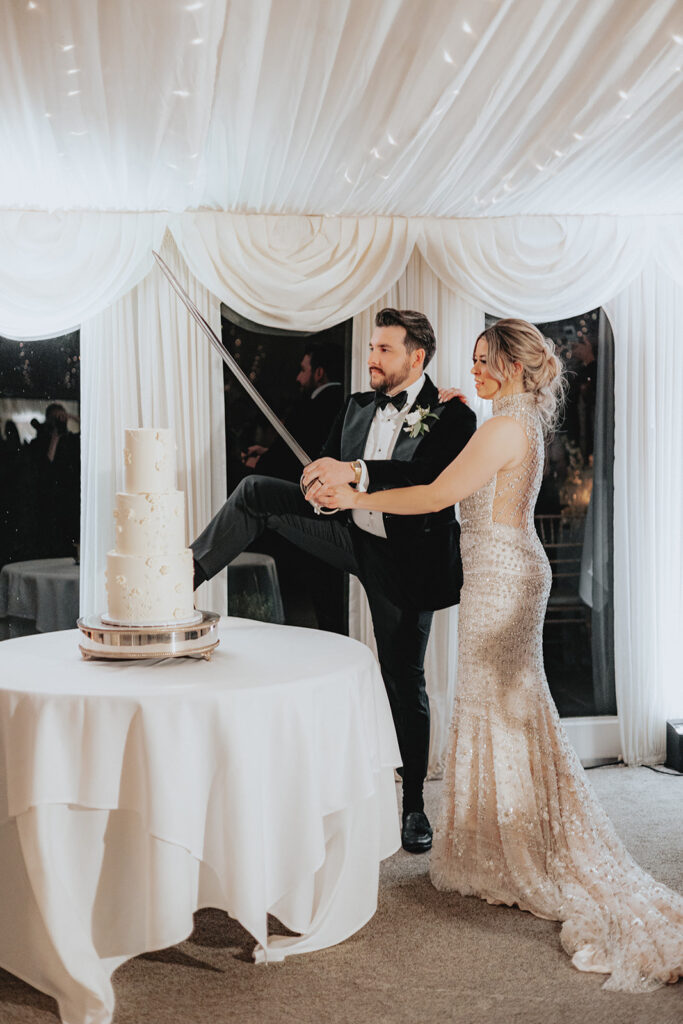 bride and groom cutting their wedding cake 