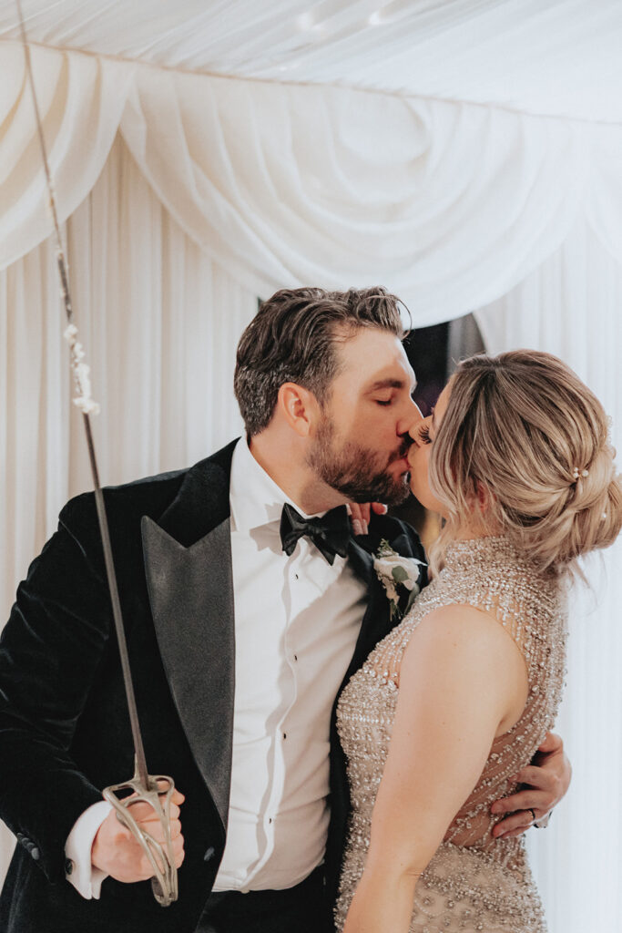 bride and groom kissing at their reception