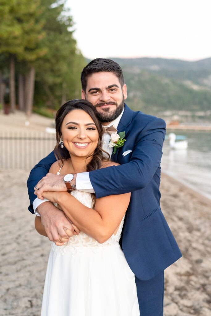 picture of the bride and groom hugging 