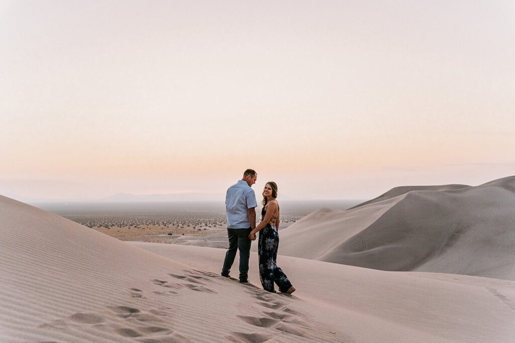 couple at the sand dunes during their engagement session