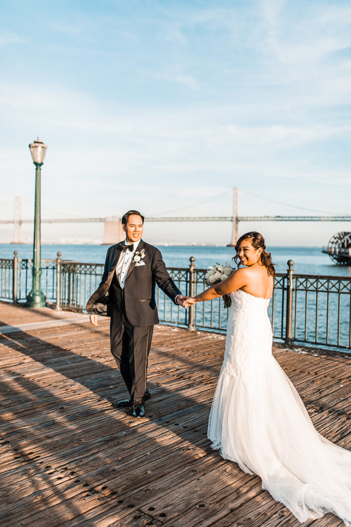 bride and groom holding hands