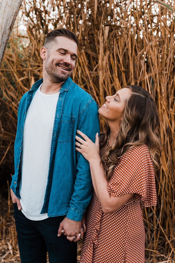 newly engaged couple looking at each other 