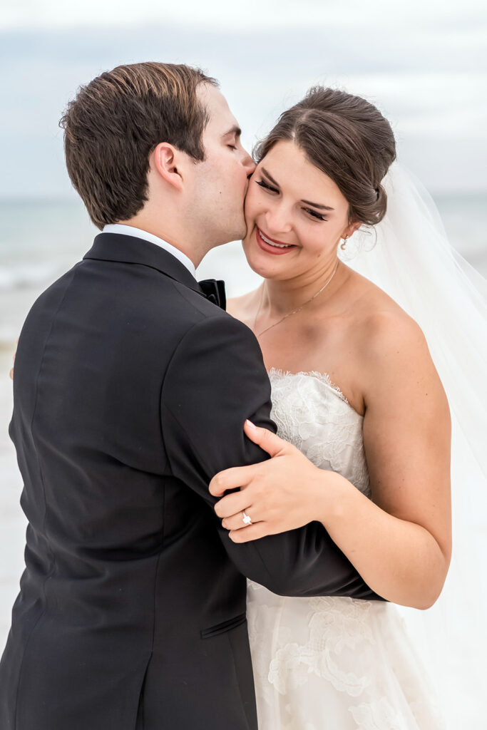 groom kissing the bride on the cheek