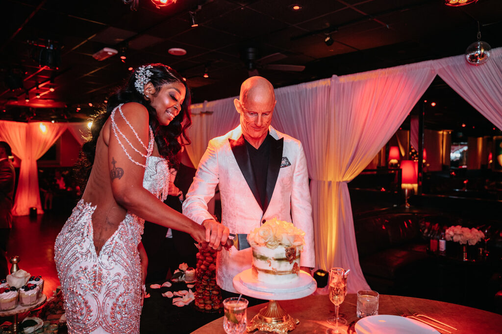 newlyweds cutting their wedding cake