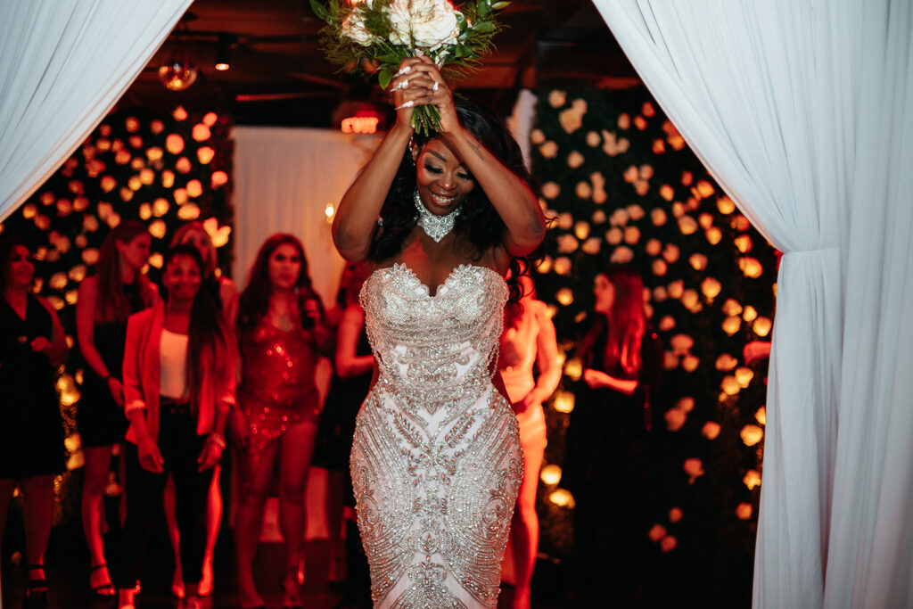 bride throwing her wedding bouquet 