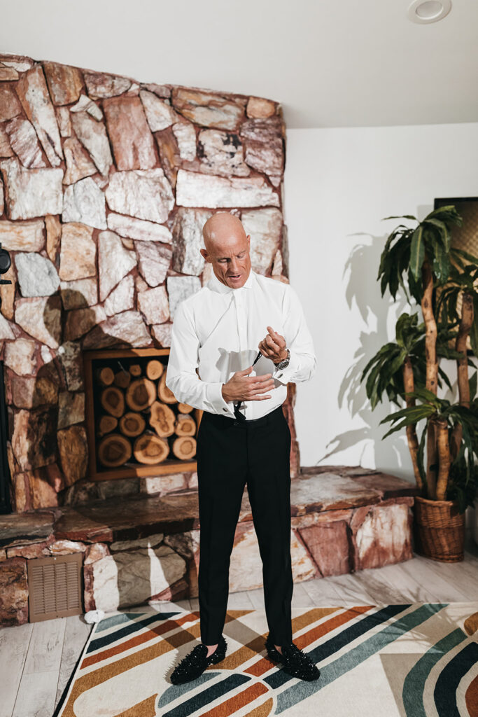 groom getting ready for his chic las vegas elopement 