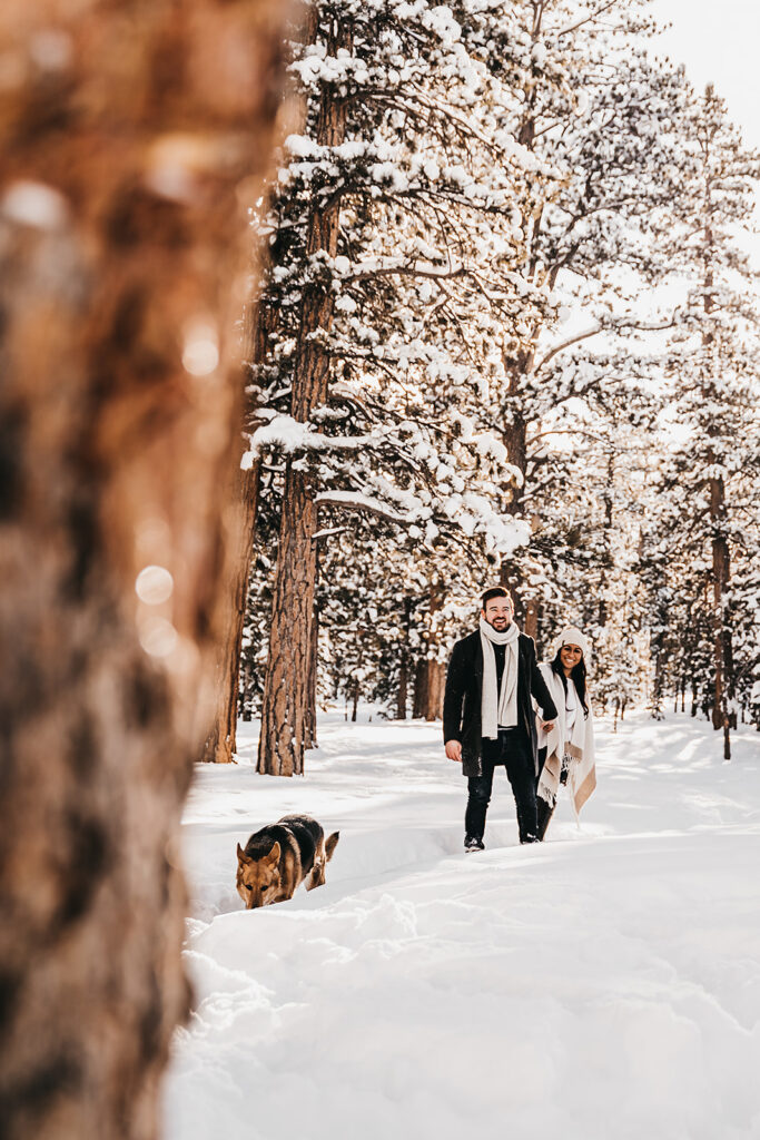 couple playing during their winter engagement session