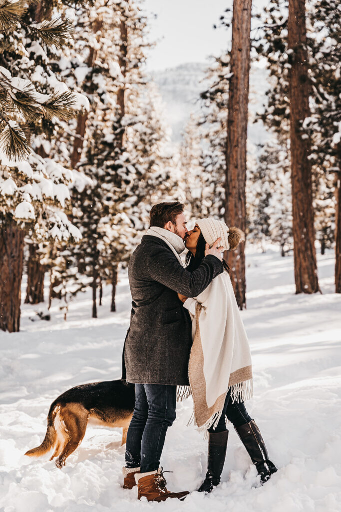 cute picture of the newly engaged couple kissing during their photoshoot