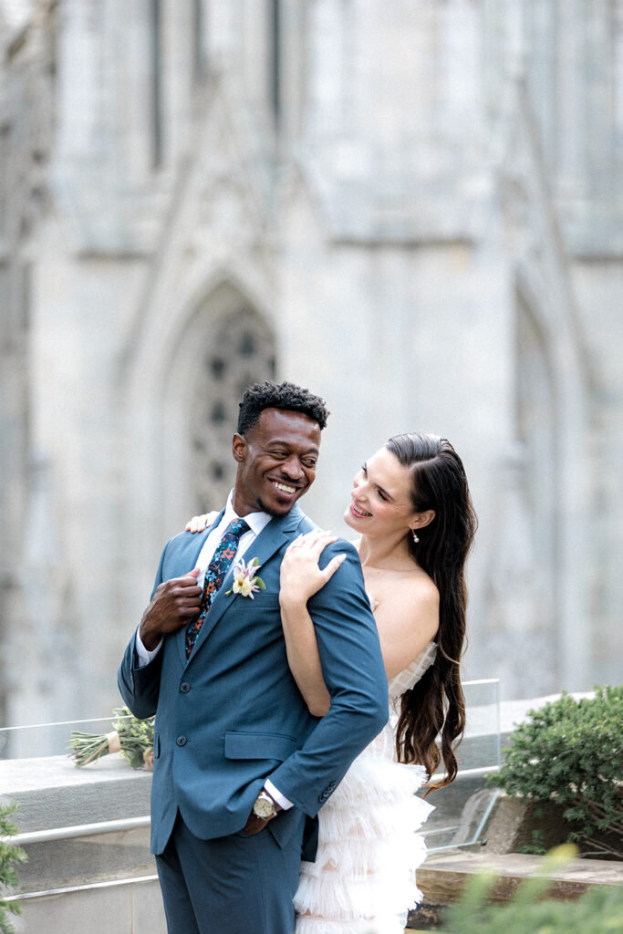 bride and groom smiling to each other 