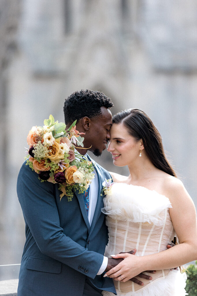 groom kissing the bride on the forehead