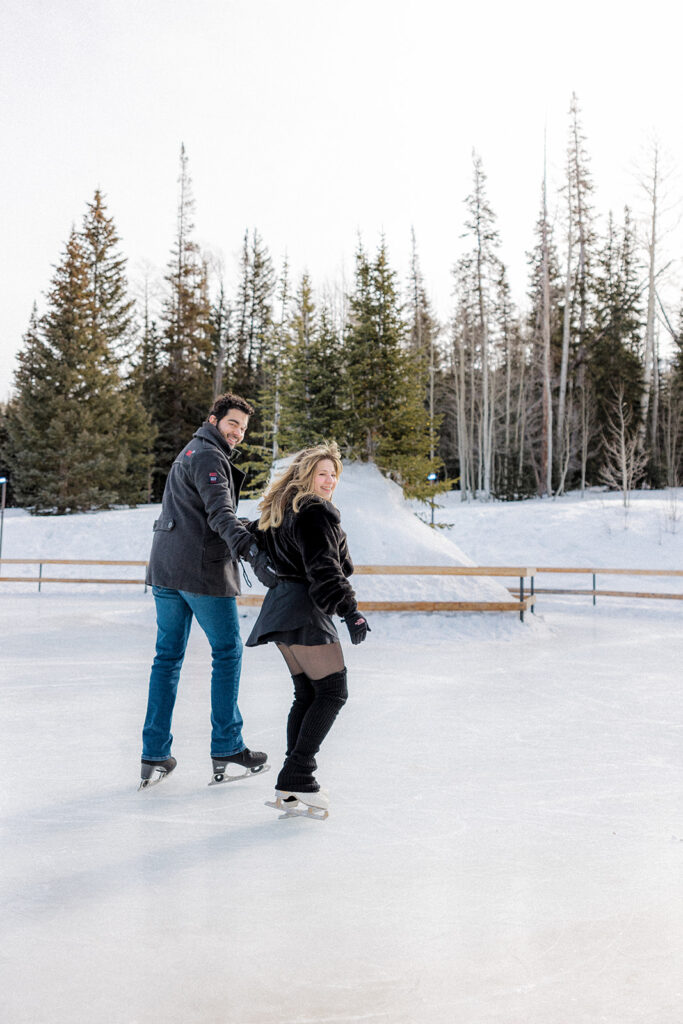 cute couple hugging during their payful winter photoshoot
