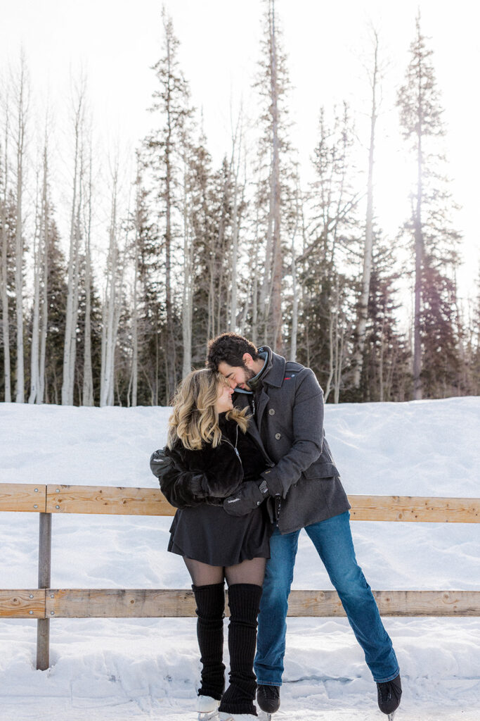 cute couple kissing during their winter photoshoot