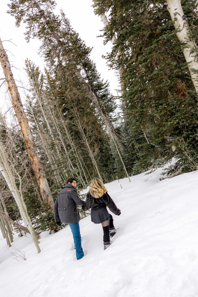couple walking around the snow during their photoshoot