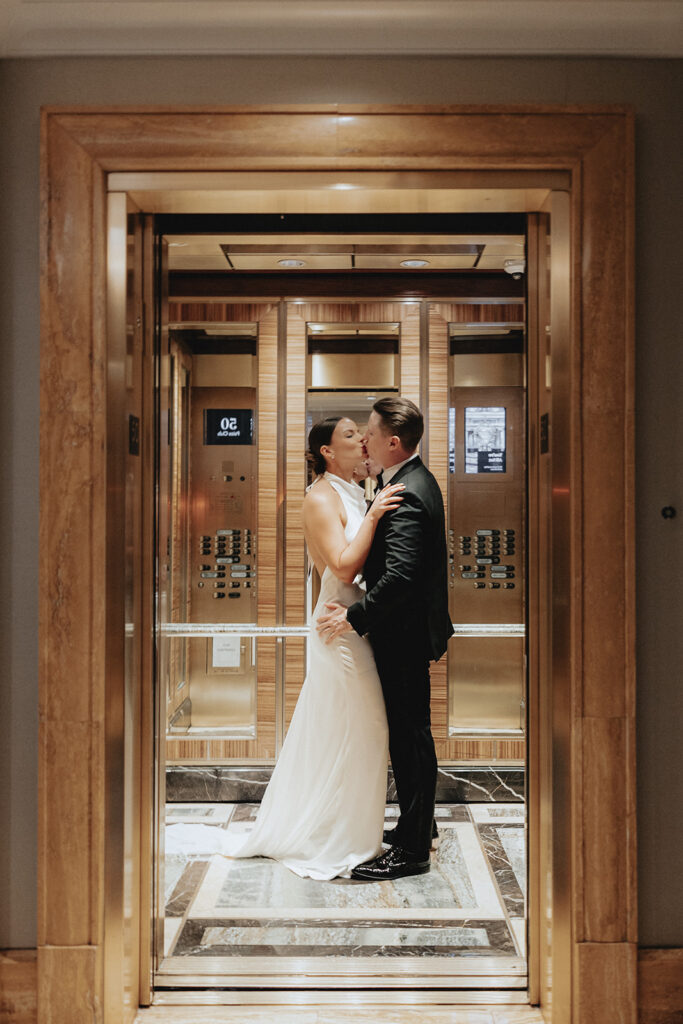 Picture of the bride and groom, kissing before heading to their ceremony