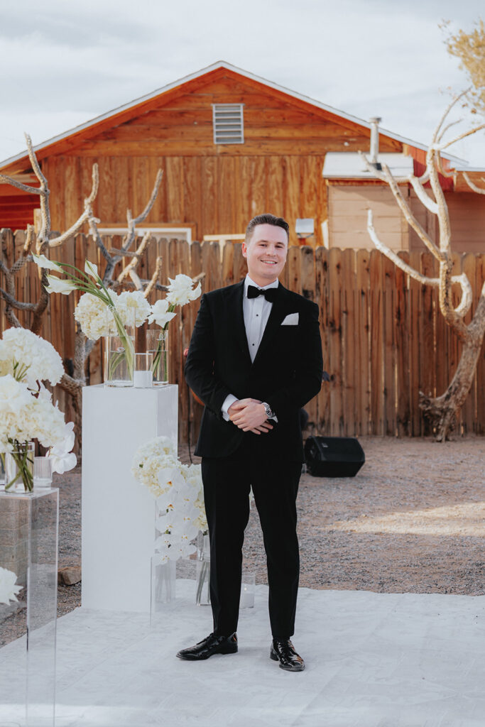 groom watching the bride walk down the aisle