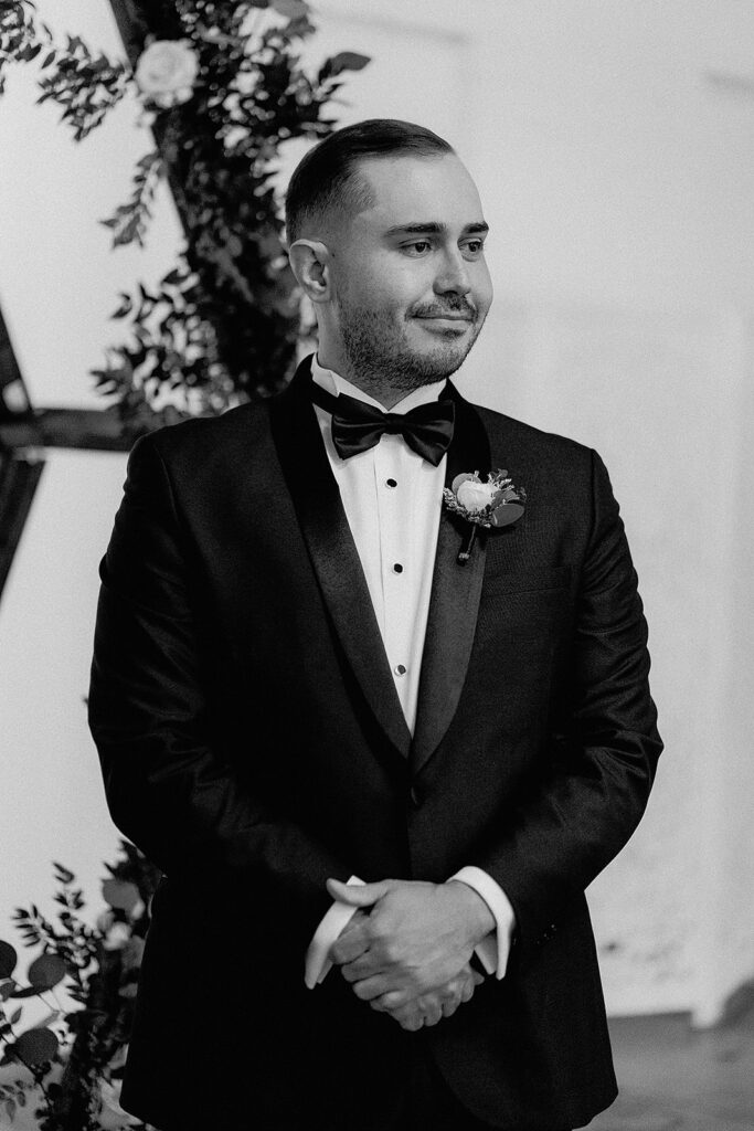 groom watching the bride walk down the aisle