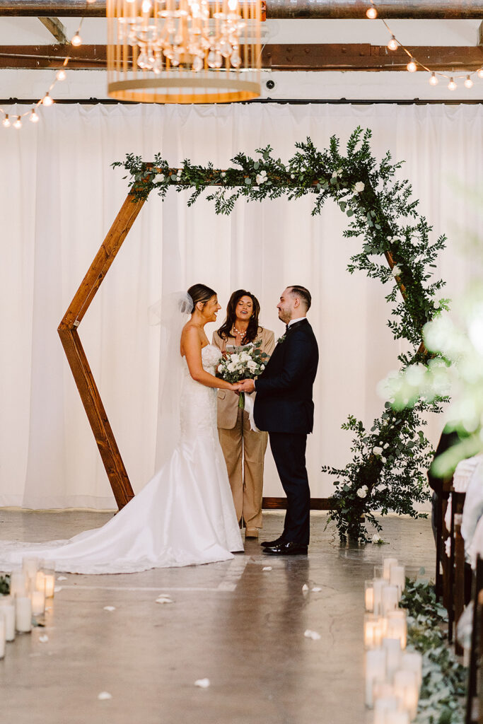 bride and groom holding hands during their wedding ceremony