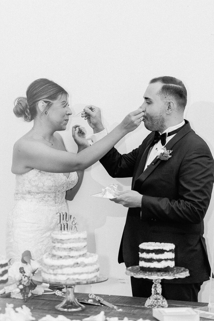 cute couple trying their wedding cake