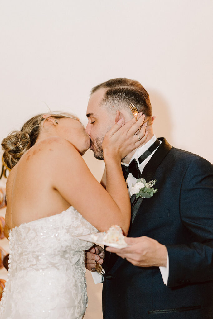 couple kissing at their wedding reception
