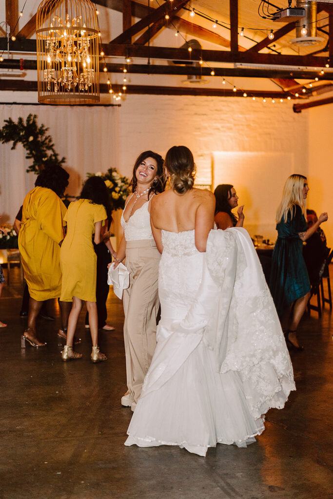 bride and her sister dancing