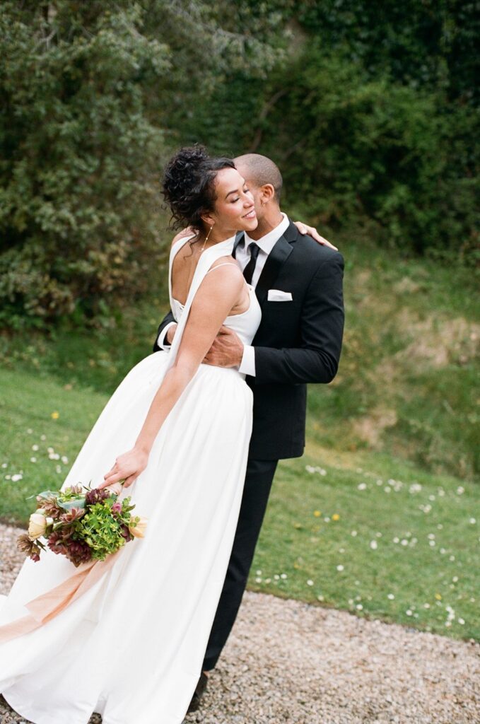 groom kissing the bride on the cheek