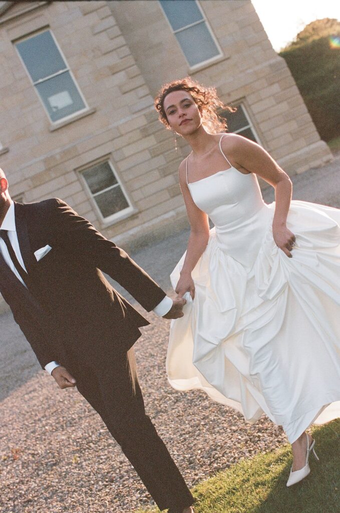 picture of the newlyweds walking around their dream wedding venue