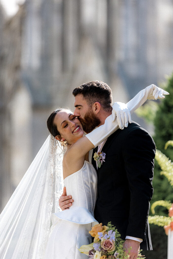 groom kissing the bride on the cheek